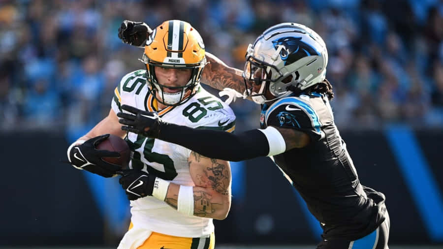 Intense Football Matchup Wallpaper