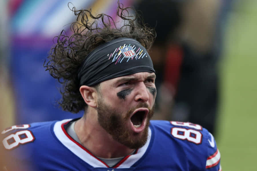 Intense Football Player Shouting During Game Wallpaper