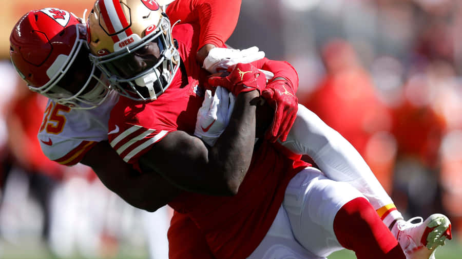 Intense Football Tackle Action Wallpaper