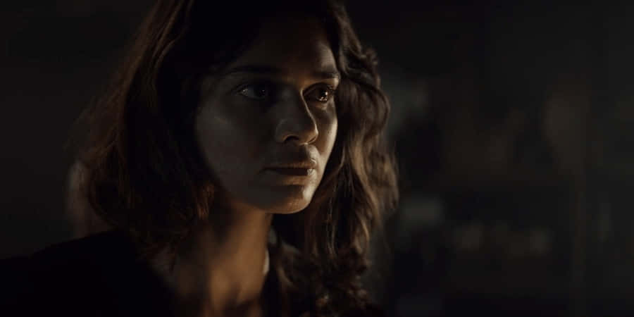 Intense_ Gaze_in_ Shadowy_ Room.jpg Wallpaper