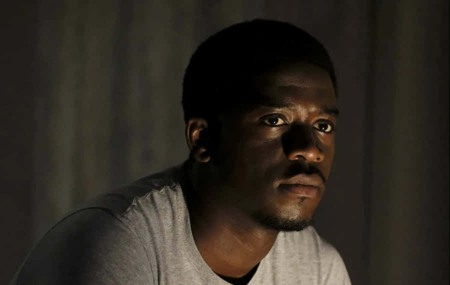 Intense_ Gaze_in_ Shadowy_ Room Wallpaper