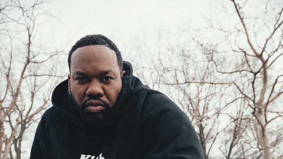 Intense Gaze Man Winter Backdrop Wallpaper