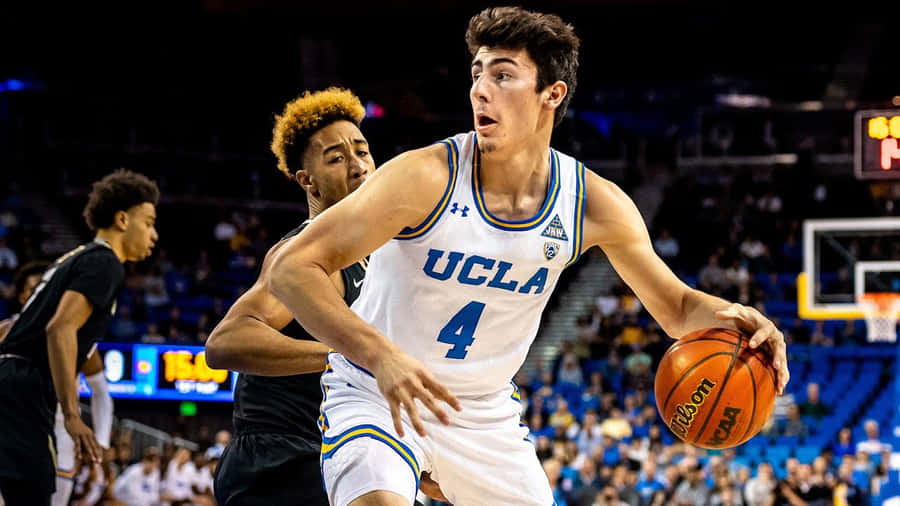 Jaime Jaquez Jr In Action During A Basketball Game Wallpaper
