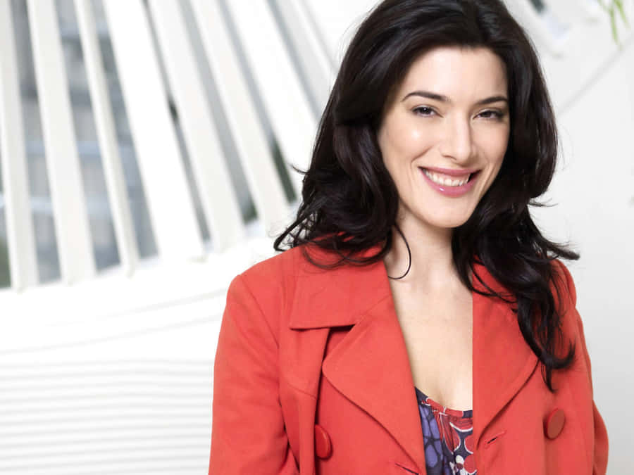 Jaime Murray Striking A Pose In An Elegant Red Dress Wallpaper