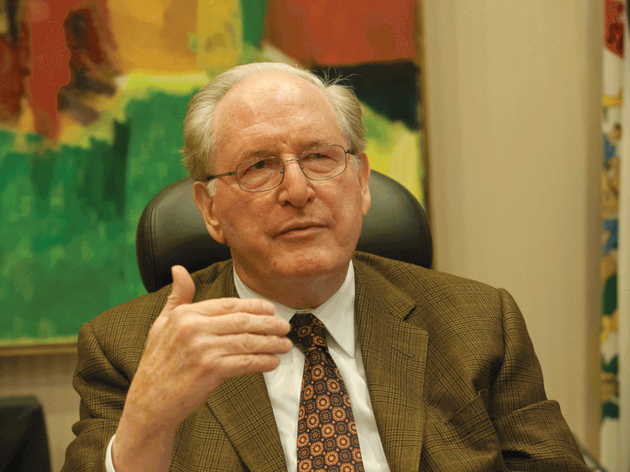 Jay Rockefeller Sitting On Black Chair Wallpaper