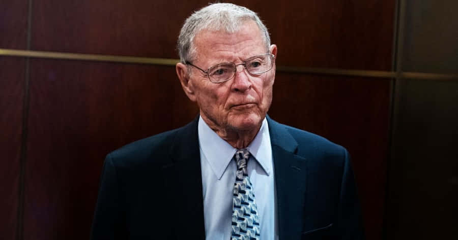 Jim Inhofe With Wooden Wall Background Wallpaper