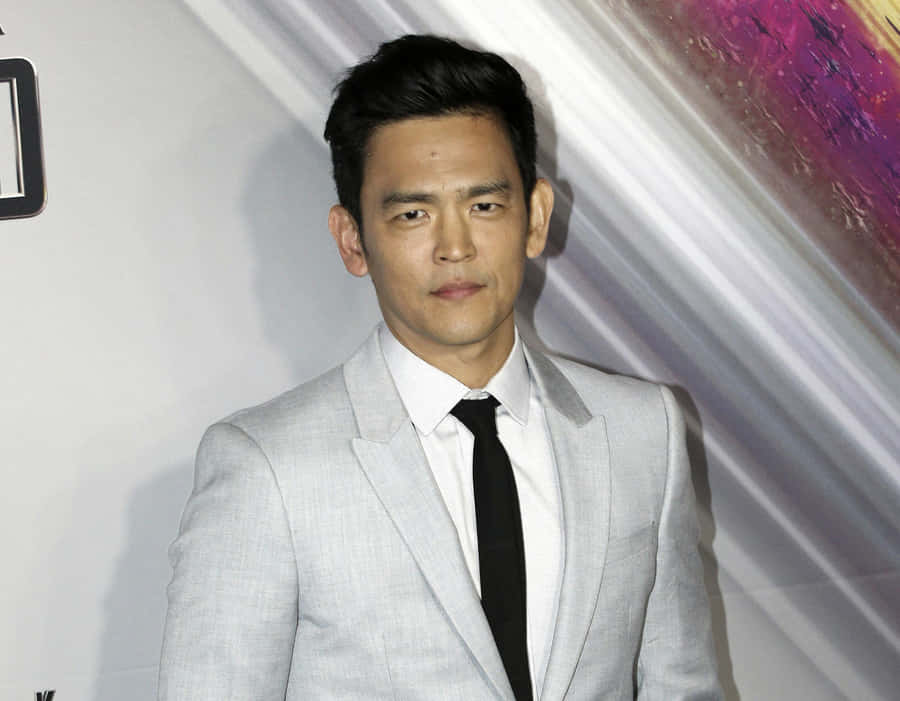 John Cho Smiles For The Camera At An Event Wallpaper