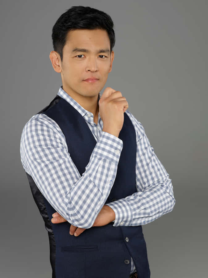 John Cho Striking A Pose During A Photoshoot Wallpaper
