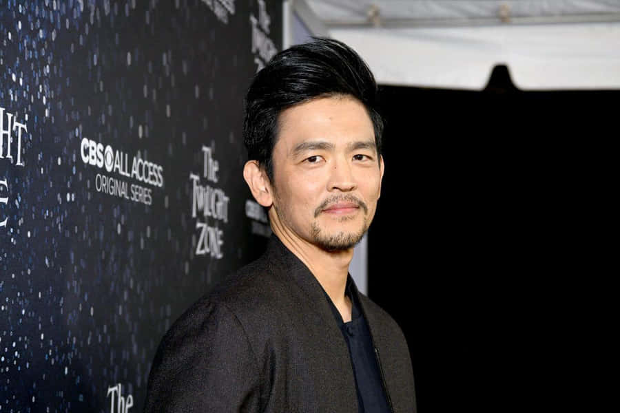 John Cho Striking A Stylish Pose In A Photoshoot Wallpaper