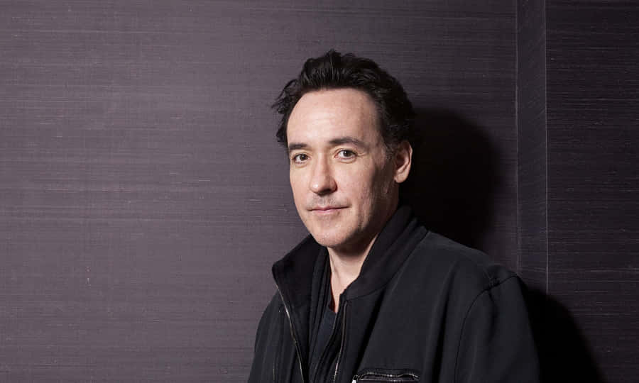 John Cusack Smiling At The Camera In A Casual Attire Wallpaper