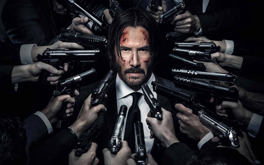 John Wick Fires Guns In An Action Packed Showdown Wallpaper