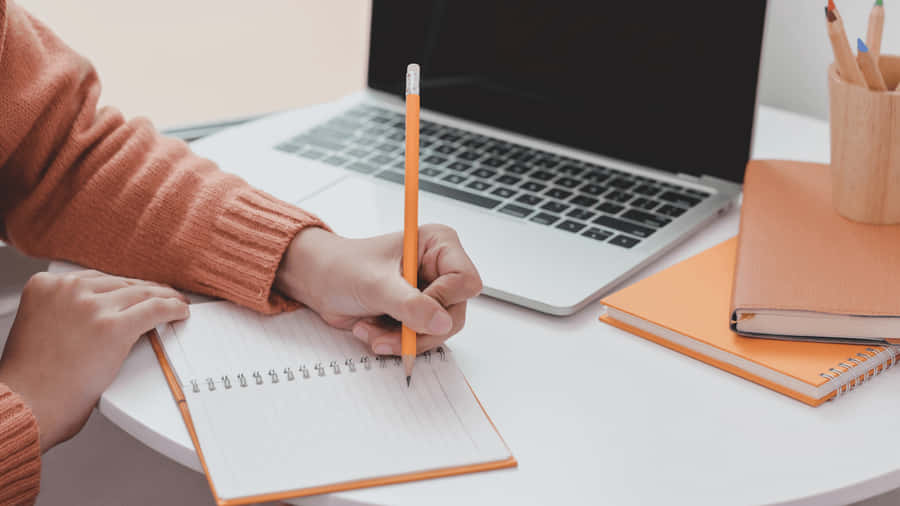 Jotting Down Notes In A Subject Wallpaper