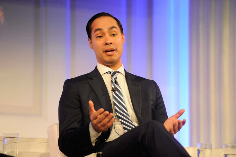 Julian Castro Sitting And Shrugging Wallpaper