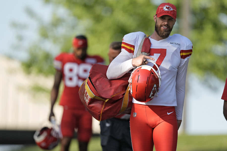 Kansas City Chiefs Player Carrying Helmetand Gear Wallpaper