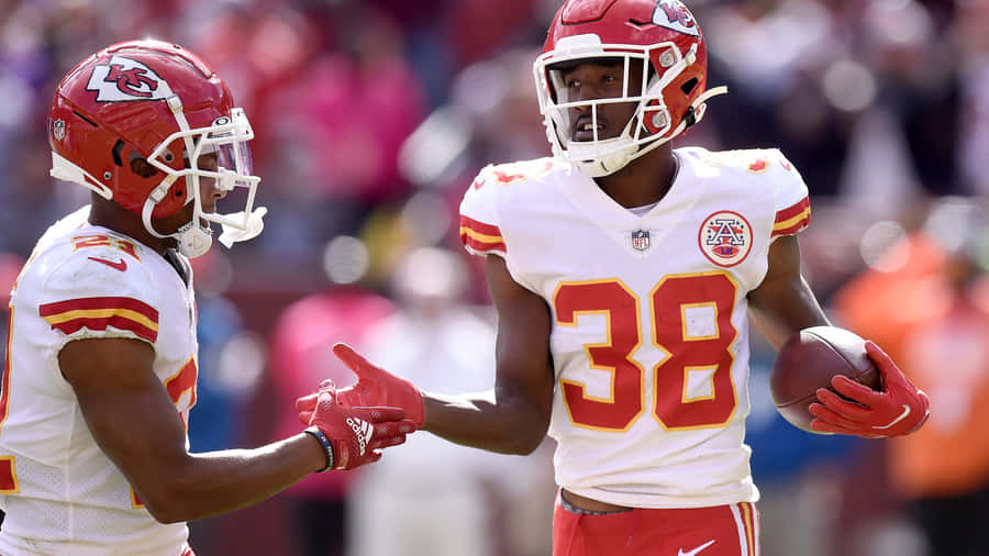 Kansas City Chiefs Players Celebrating On Field Wallpaper