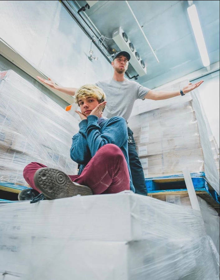 Karl Jacobs Sitting On Cargo Boxes Wallpaper