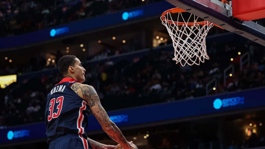 Kyle Kuzma Dunking Action Wallpaper
