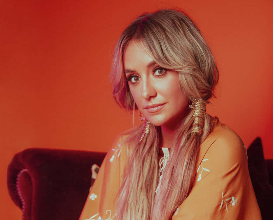 Lainey Wilson Orange Backdrop Portrait Wallpaper
