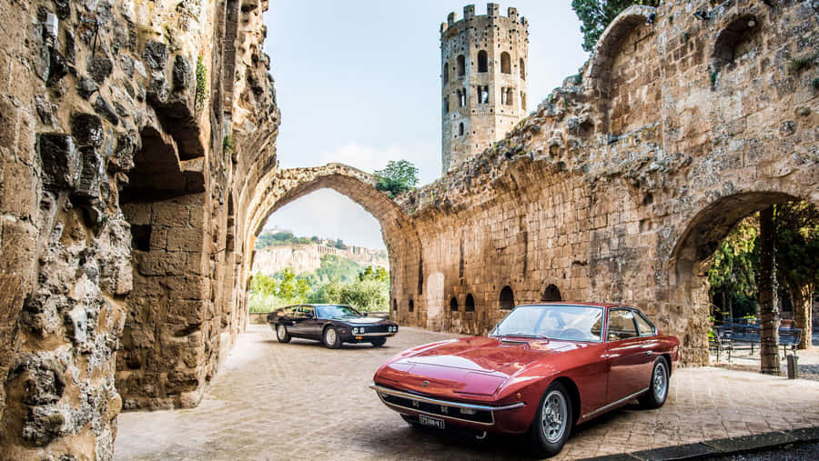 Lamborghini Islero Pair Castle Backdrop Wallpaper