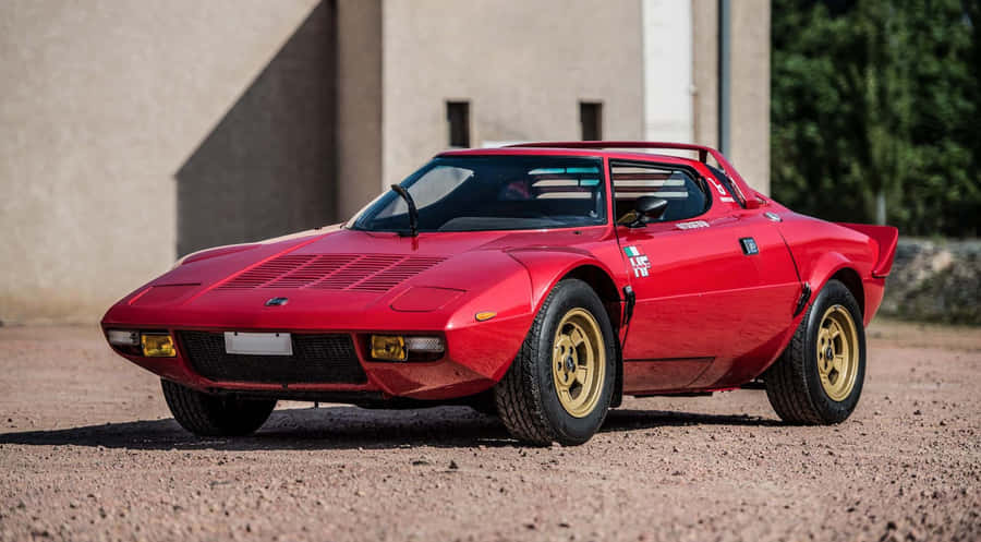 Lancia Classic Car On A Peaceful Road Wallpaper