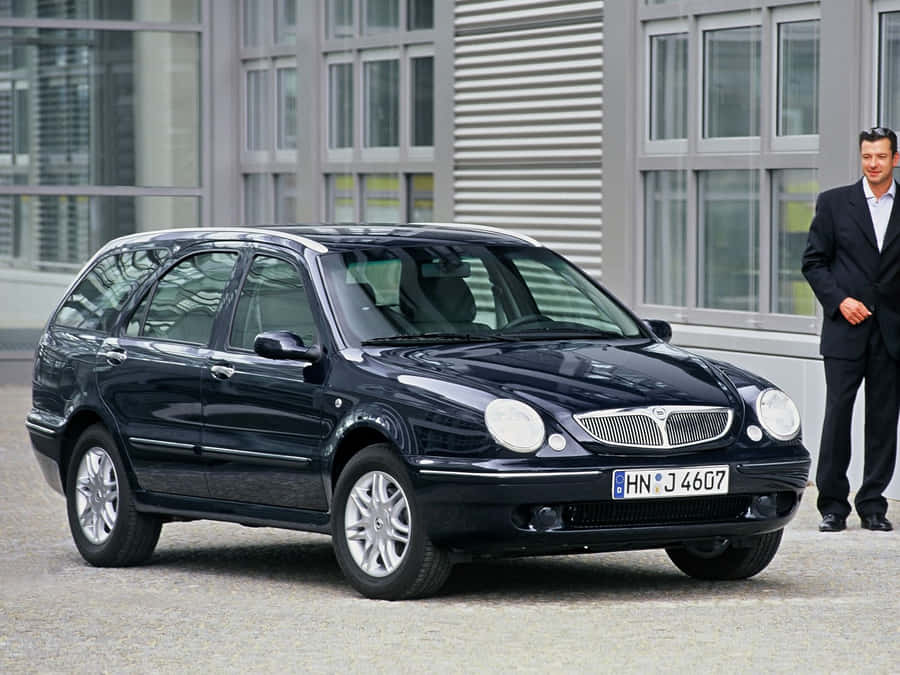 Lancia Lybra Executive Car With Man Standing Wallpaper