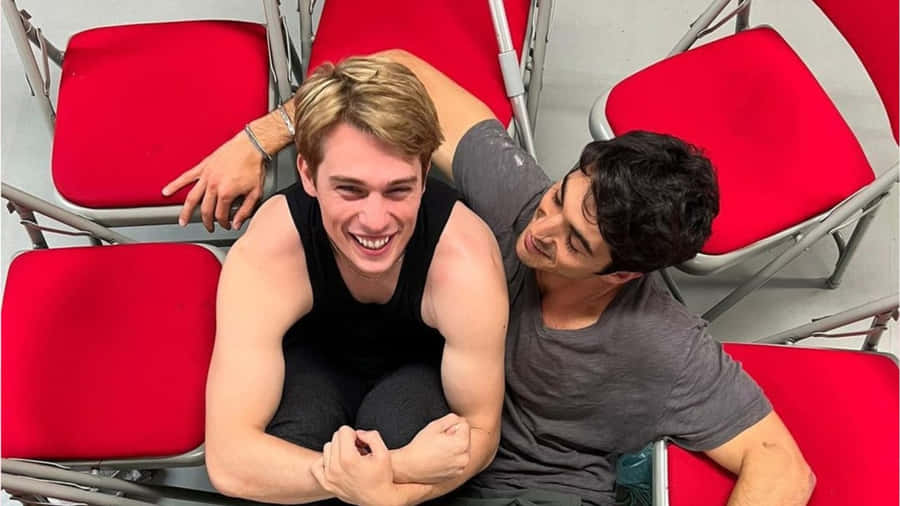 Laughing Duo Red Chairs Wallpaper