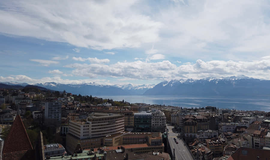 Lausanne Cityscapewith Lake Genevaand Alps Wallpaper