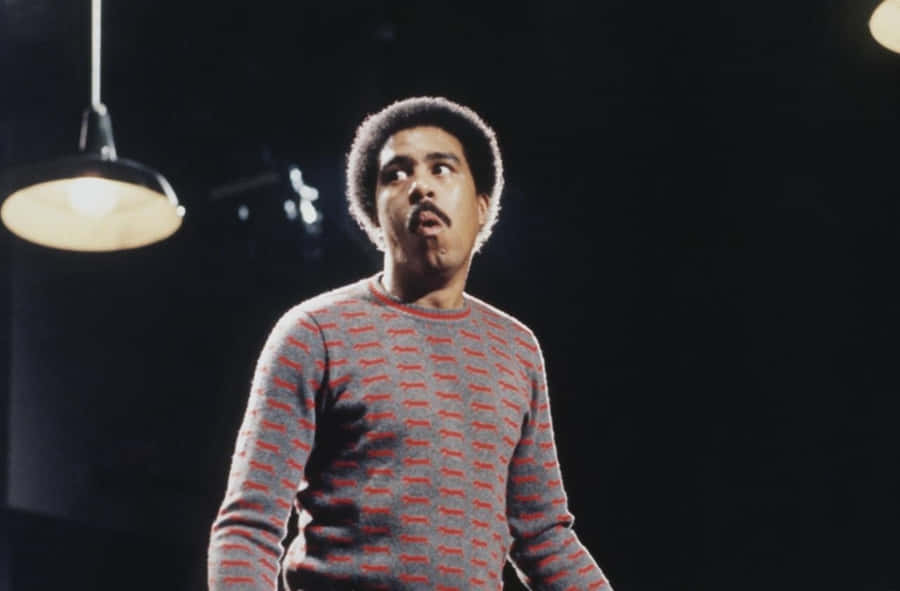 Legendary Comedian Richard Pryor Against Sky-blue Background Wallpaper