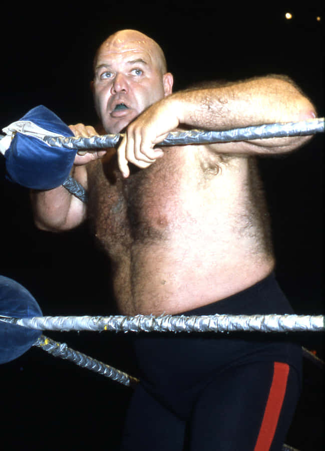 Legendary Wrestler George Steele Leaning On Wrestling Ring Wallpaper