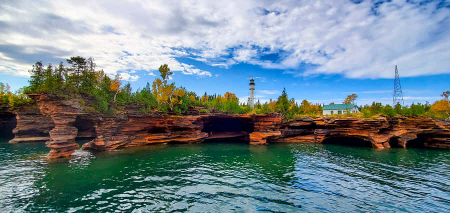 Lighthouse_ Above_ Cliffside_ Caves Wallpaper