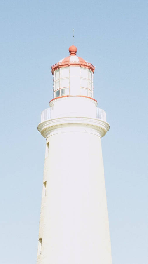 Lighthouse On A Baby Blue Sky Wallpaper