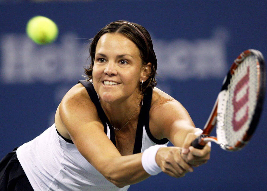 Lindsay Davenport Hitting Tennis Ball And Smiling Wallpaper