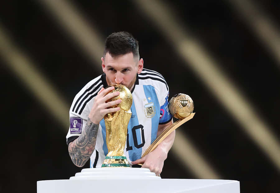 Lionel Messi Kissing World Cup Trophy Wallpaper