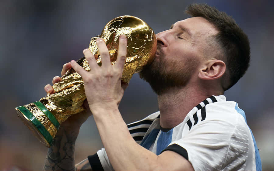 Lionel Messi Kissing World Cup Trophy Wallpaper