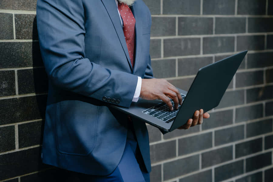 Look Confident And Professional With A Navy Blue Suit Wallpaper