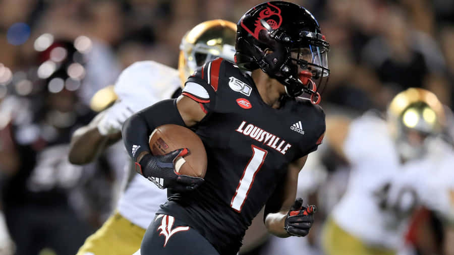 Louisville Football Player Running With Ball Wallpaper