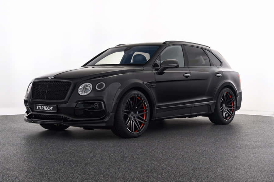 Luxurious Bentley Bentayga Cruising On A Scenic Route Wallpaper