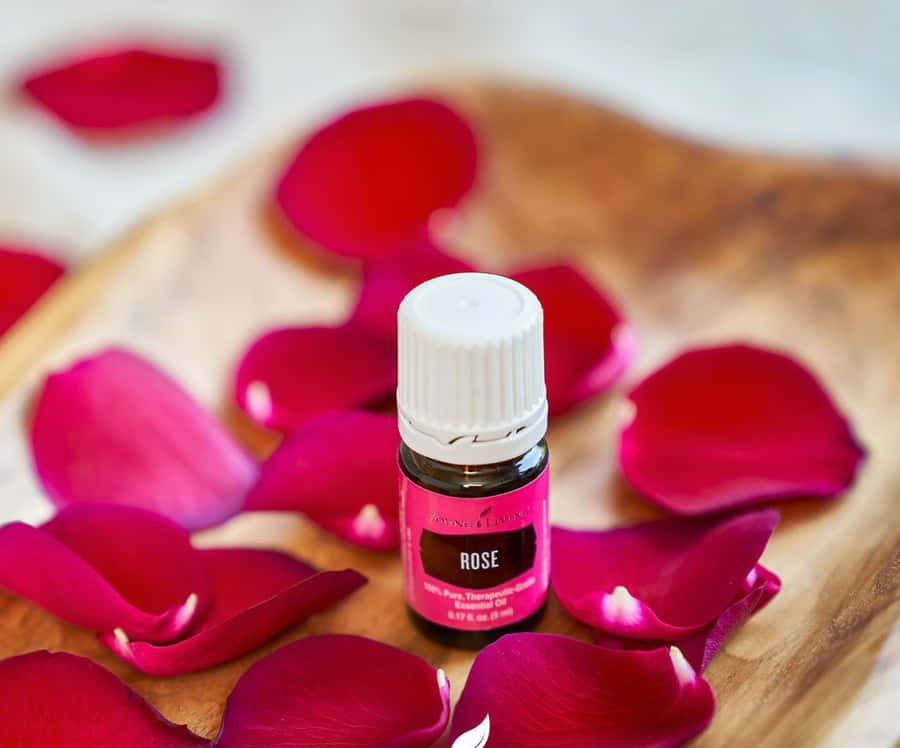 Luxurious Rose Oil In A Bottle And Fresh Blooms Wallpaper