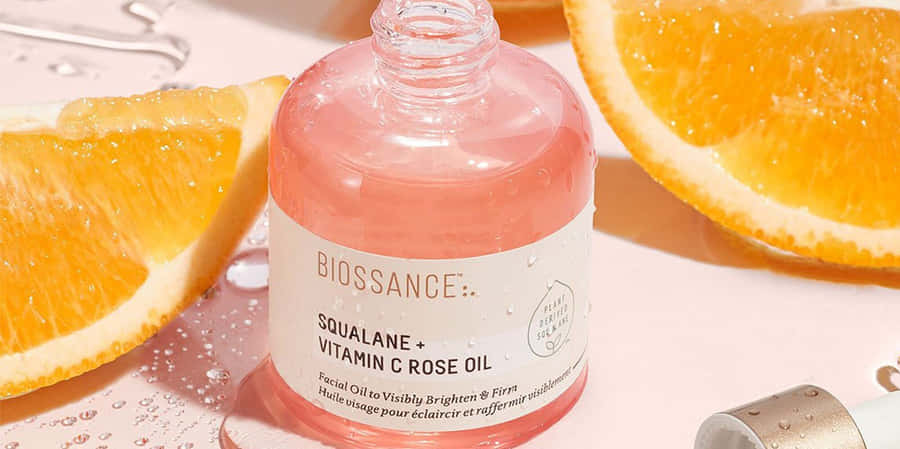 Luxurious Rose Oil In A Glass Bottle Wallpaper