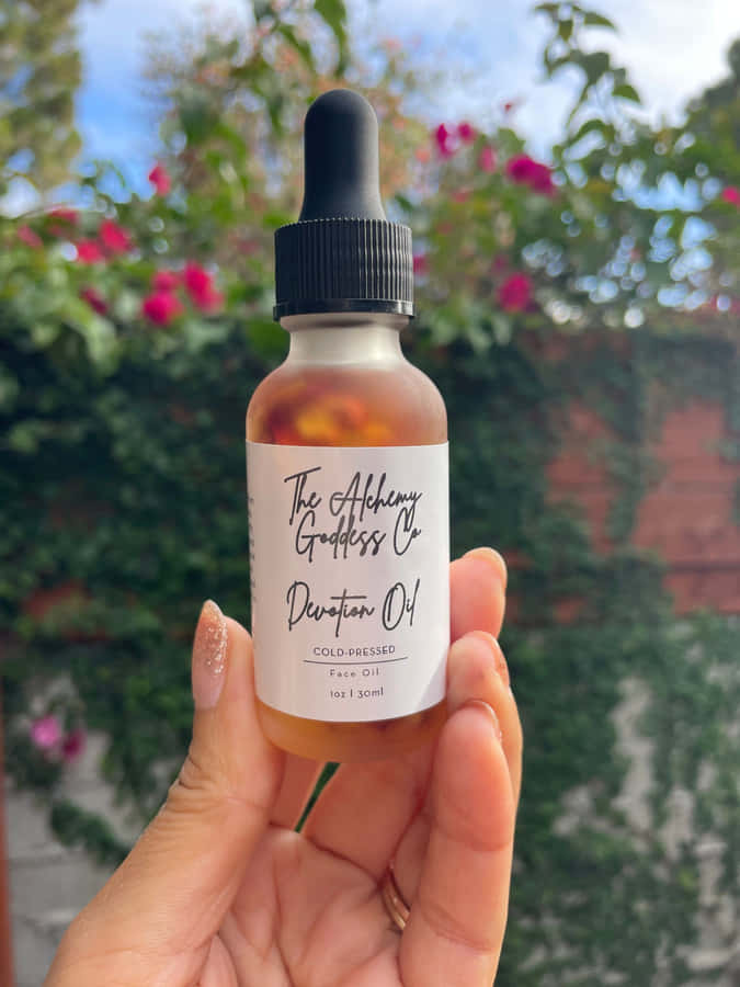 Luxurious Rose Oil In A Glass Dropper Bottle Wallpaper