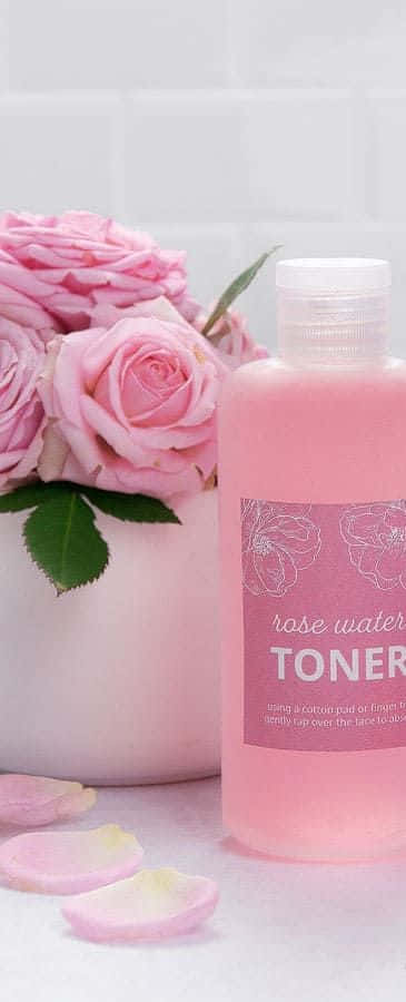 Luxurious Rose Oil In An Elegant Glass Dropper Bottle Surrounded By Bright Red Roses. Wallpaper