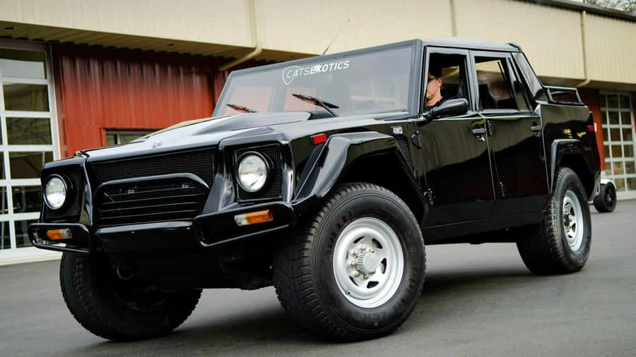 Luxury Meets Adventure: The Classic Lamborghini Lm002 Wallpaper
