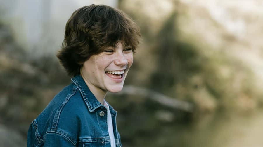 Maddox Batson Smiling Outdoors Wallpaper