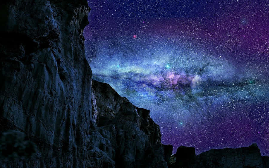 Magical Night Sky With Many Stars Over Rocky Mountains Wallpaper