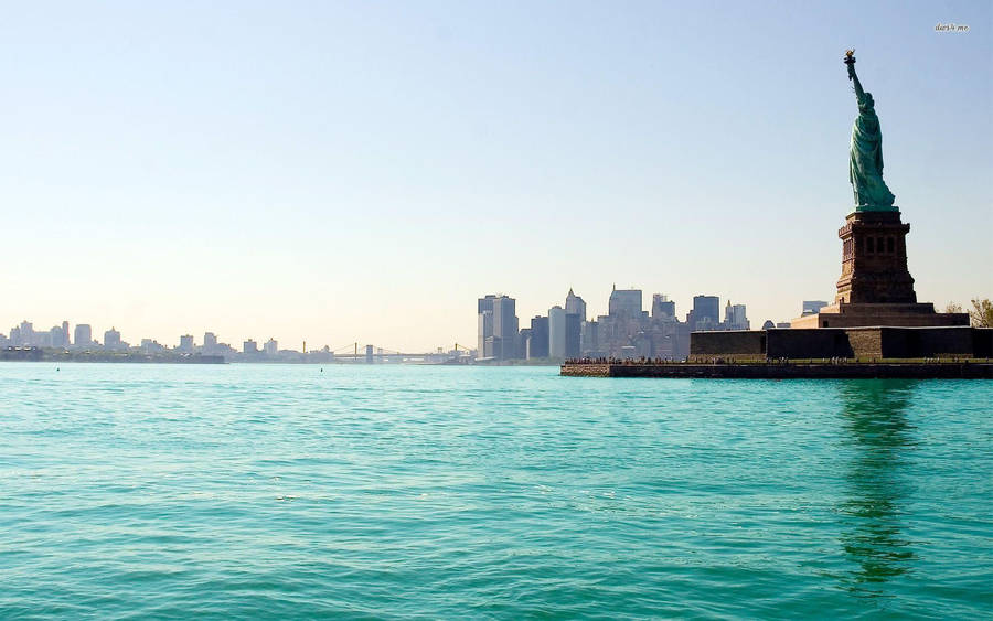 Magnificent Statue Of Liberty Overlooking The Harbor Wallpaper