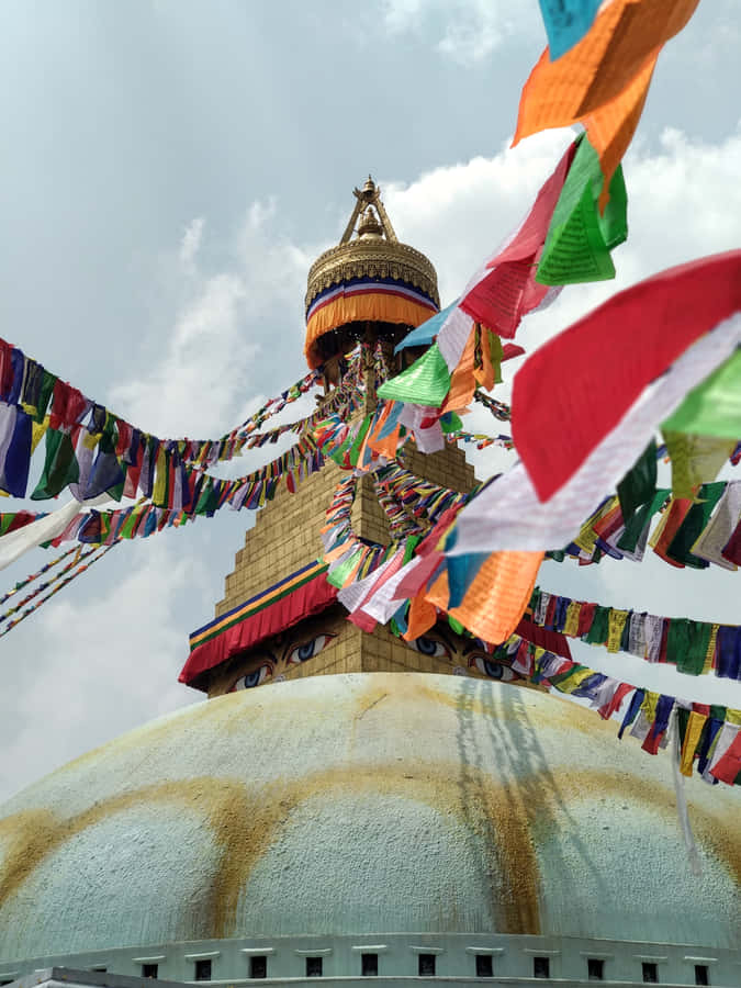 Majestic Boudhanath Stupa Adorned With Colorful Prayer Flags Wallpaper