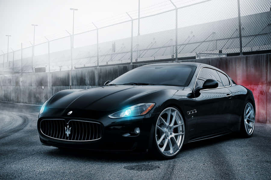 Majestic Maserati Quattroporte Gliding Through City Streets Wallpaper