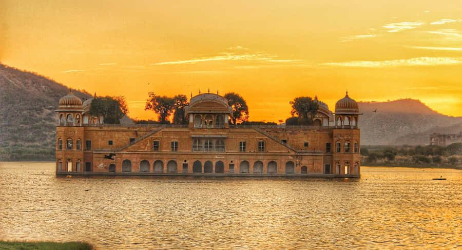 Majestic Mountain Summit Overlooking A Lake Wallpaper