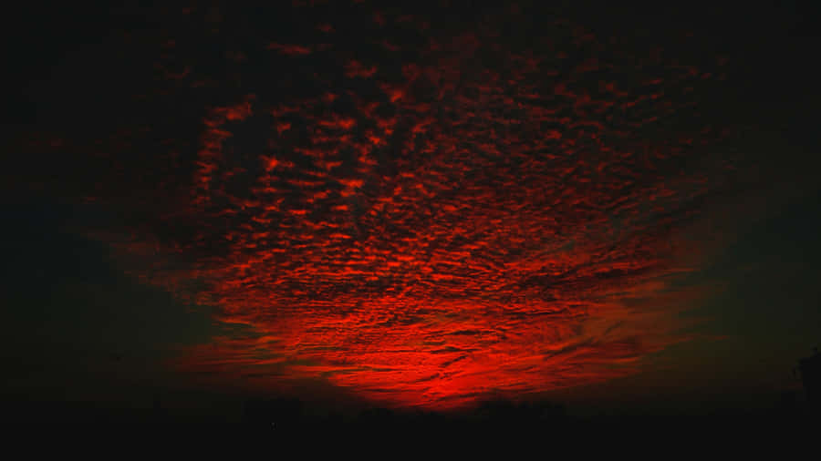 Majestic Red Sunset Over The Horizon Wallpaper