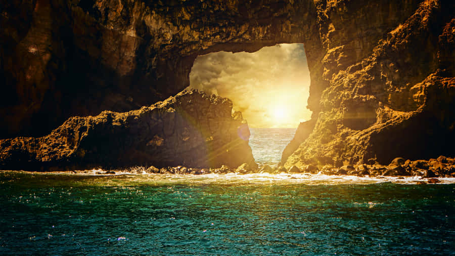 Majestic Sunrise Over A Coastal Shoreline Wallpaper